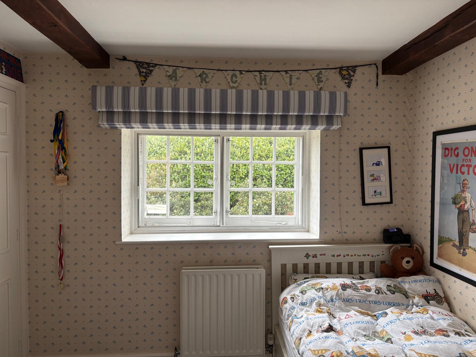 Navy ticking stripe Roman blind in a child's bedroom