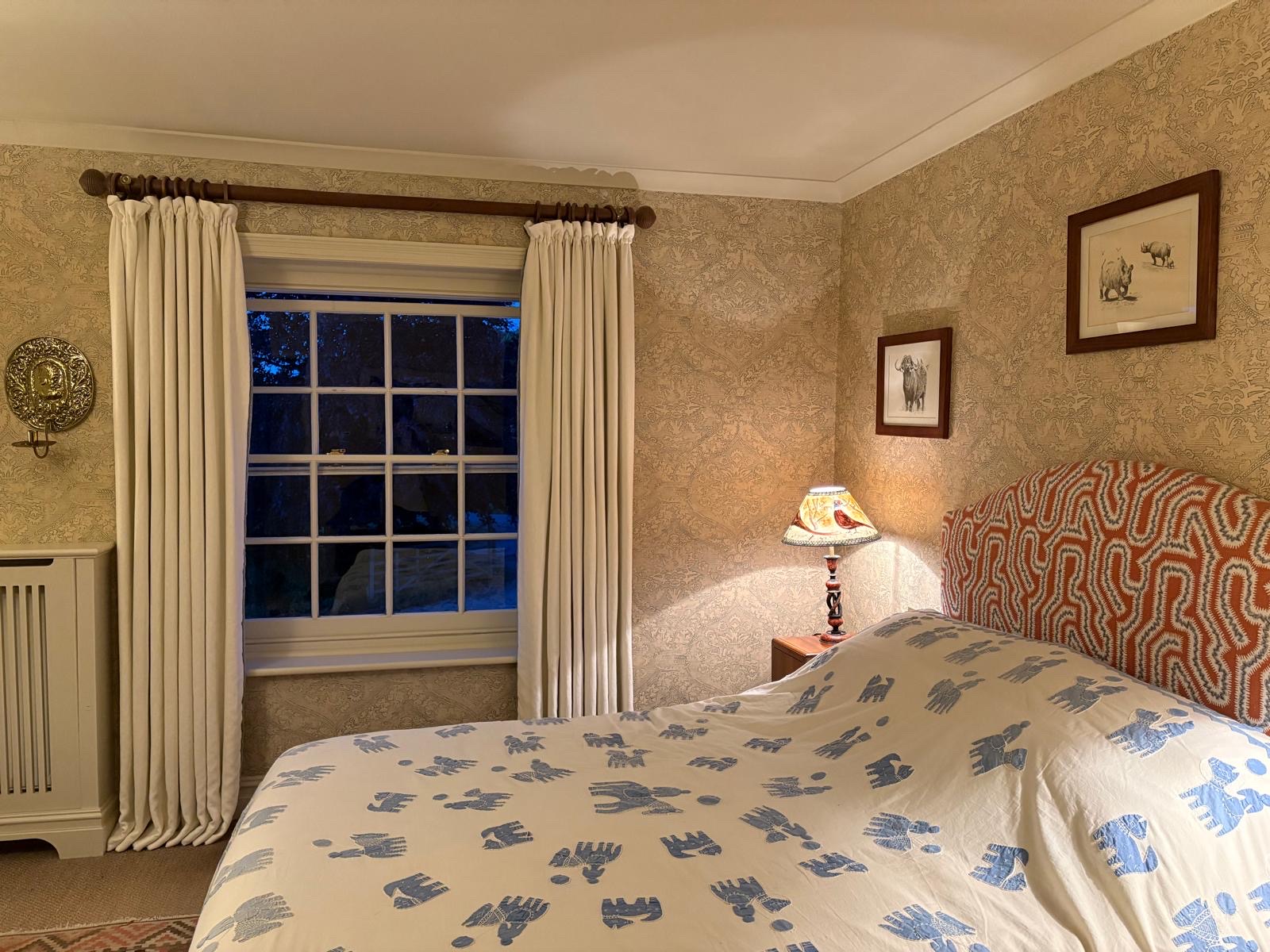 Cream interlined curtains on a wooden pole, bedroom