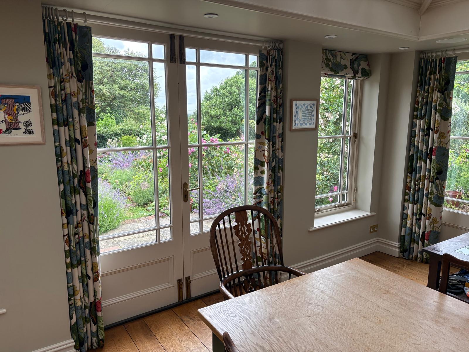 Lily print curtains and matching Roman blind in a dining room